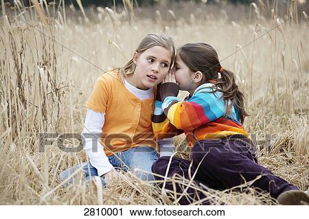 Stock Image - Friends gossiping in forest . Fotosearch