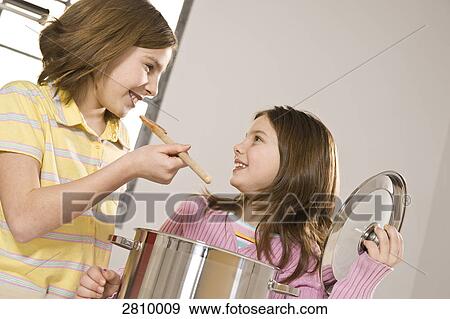 Friends smelling food in kitchen View Large Photo Image Stock Photo - Friends smelling food in kitchen . Fotosearch