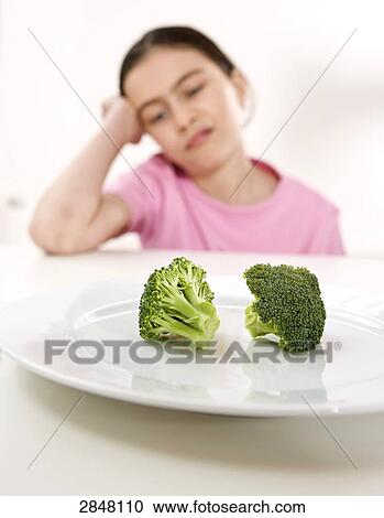 Girl disliking broccoli View Large Photo Image Stock Image - Girl disliking broccoli . Fotosearch