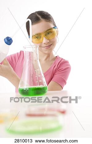 Stock Image - Girl doing experiment in chemistry laboratory . Fotosearch