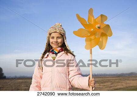 Girl holding pinwheel and smiling View Large Photo Image Stock Image - Girl holding pinwheel and smiling . Fotosearch