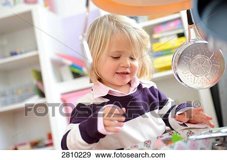 Stock Photo - Girl looking at candies . Fotosearch