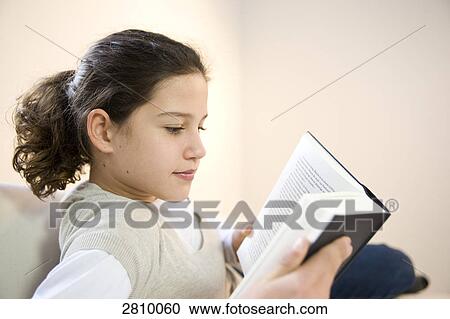 Stock Image - Girl reading book . Fotosearch