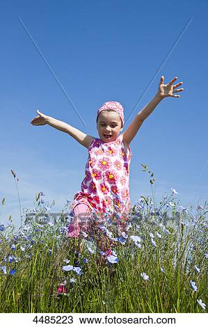 Girl running over flower meadow View Large Photo Image Stock Image - Girl running over flower meadow . Fotosearch