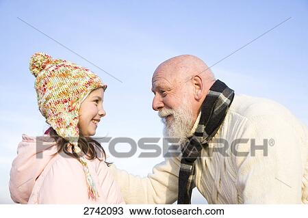 Girl smiling with her grandfather View Large Photo Image Stock Image - Girl smiling with her grandfather . Fotosearch