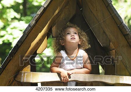 Girl standing in tree house View Large Photo Image Stock Photography - Girl standing in tree house . Fotosearch
