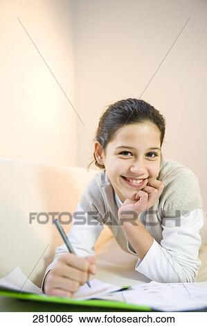 Girl writing on sheet of paper and smiling View Large Photo Image Stock Photography - Girl writing on sheet of paper and smiling . Fotosearch