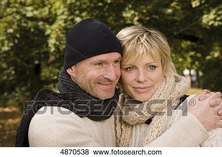 Happy couple embracing outdoors View Large Photo Image Stock Photo - Happy couple embracing outdoors . Fotosearch