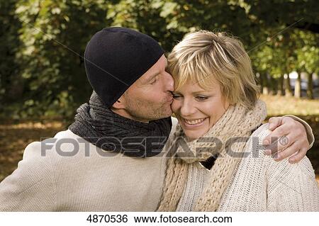 Stock Photograph - Happy couple embracing outdoors . Fotosearch