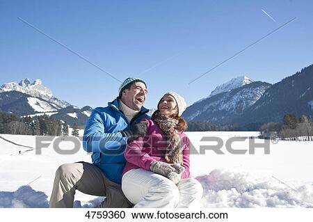 Stock Image - Happy couple in winter landscape, Tannheimer Tal, Tyrol, Austria . Fotosearch