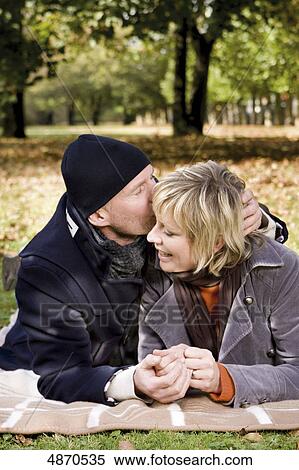 Happy couple lying on blanket in park View Large Photo Image Stock Photography - Happy couple lying on blanket in park . Fotosearch