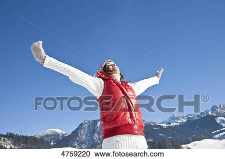 Stock Image - Happy woman in winter landscape, Tannheimer Tal, Tyrol, Austria . Fotosearch