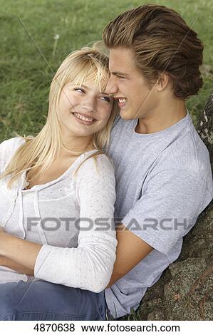 Stock Photo - Happy young couple embracing outdoors . Fotosearch