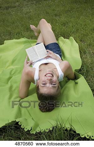 Happy young woman listening to music in meadow View Large Photo Image Stock Image - Happy young woman listening to music in meadow . Fotosearch