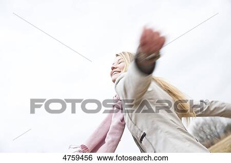 Happy young woman outdoors View Large Photo Image Stock Photograph - Happy young woman outdoors . Fotosearch
