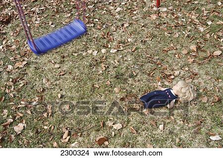 High angle view of swing and doll in field View Large Photo Image Picture - High angle view of swing and doll in field . Fotosearch