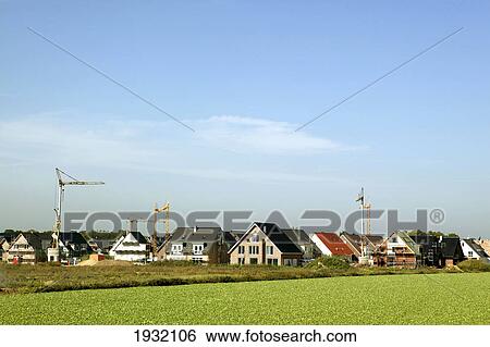 Houses and cranes in town View Large Photo Image Stock Photograph - Houses and cranes in town . Fotosearch