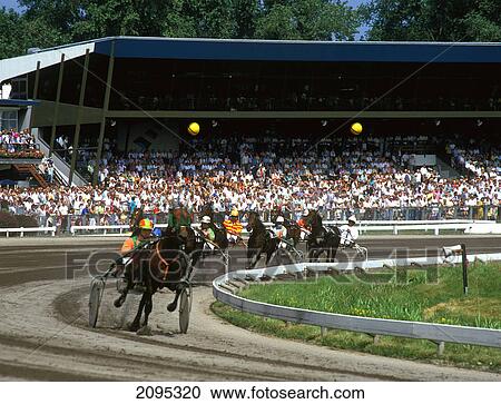 Stock Image - Jockies participating in harness race . Fotosearch