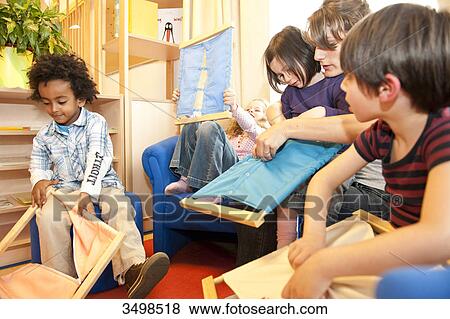 Kindergarten teacher and children playing with fasteners frames View Large Photo Image Stock Photo - Kindergarten teacher and children playing with fasteners frames . Fotosearch