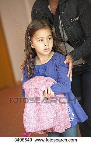 Stock Photo - Kindergarten teacher standing behind young girl . Fotosearch