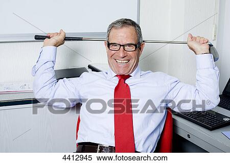 Laughing businessman holding golf club View Large Photo Image Stock Photography - Laughing businessman holding golf club . Fotosearch