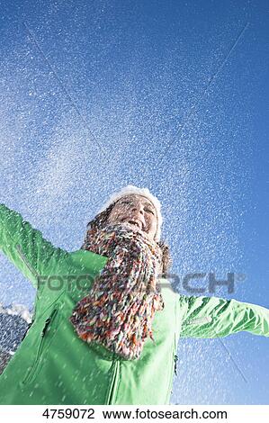Laughing woman in snow, Tannheimer Tal, Tyrol, Austria View Large Photo Image Stock Image - Laughing woman in snow, Tannheimer Tal, Tyrol, Austria . Fotosearch