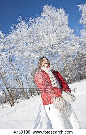 Laughing woman in snow, Tannheimer Tal, Tyrol, Austria View Large Photo Image Stock Photo - Laughing woman in snow, Tannheimer Tal, Tyrol, Austria . Fotosearch