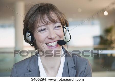Picture - Laughing woman with headset . Fotosearch