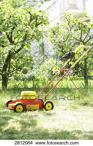Lawn mower in garden View Large Photo Image Picture - Lawn mower in garden . Fotosearch