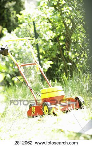 Lawn mower in garden View Large Photo Image Stock Image - Lawn mower in garden . Fotosearch