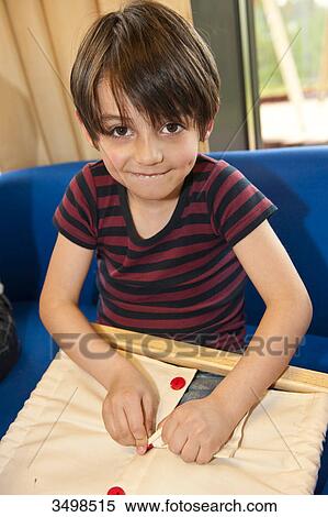 Little boy buttoning View Large Photo Image Stock Photography - Little boy buttoning . Fotosearch