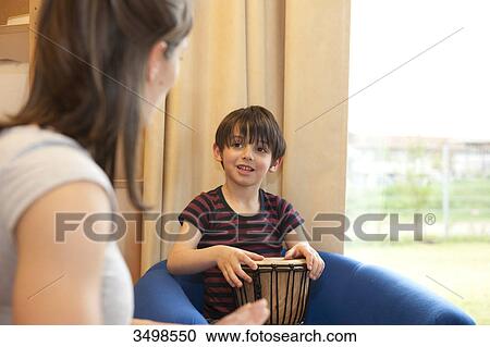 Little boy making music with kindergarten teacher View Large Photo Image Stock Image - Little boy making music with kindergarten teacher . Fotosearch