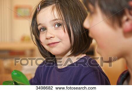 Stock Image - Little girl and boy in a kindergarten . Fotosearch