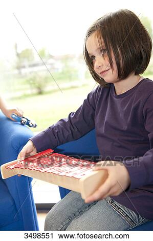 Little girl holding a xylophone View Large Photo Image Stock Image - Little girl holding a xylophone . Fotosearch