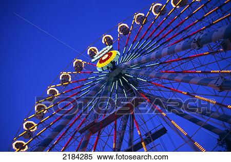 Stock Photography - Low angle view of ferris wheel lit up at night . Fotosearch