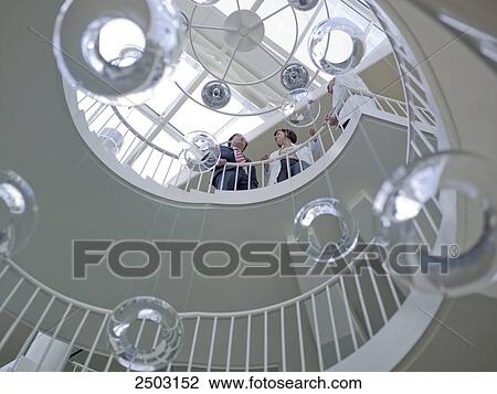 Stock Image - Low angle view of spiral staircase in hospital . Fotosearch