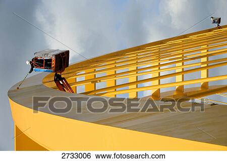 Low angle view of worker standing in basket at steel construction site View Large Photo Image Stock Photograph - Low angle view of worker standing in basket at steel construction site . Fotosearch
