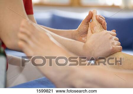 Stock Image - Low section view of person receiving foot massage . Fotosearch