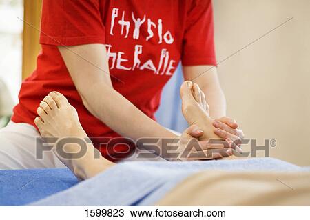 Low section view of person receiving foot massage View Large Photo Image Stock Image - Low section view of person receiving foot massage . Fotosearch