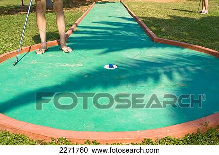 Low section view of woman playing miniature golf View Large Photo Image Stock Image - Low section view of woman playing miniature golf . Fotosearch