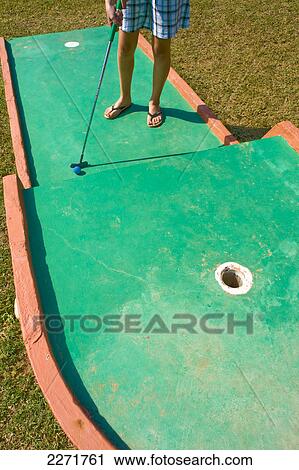 Low section view of woman playing miniature golf View Large Photo Image Stock Image - Low section view of woman playing miniature golf . Fotosearch