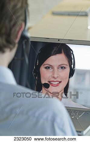 Male customer service representative working on laptop View Large Photo Image Stock Image - Male customer service representative working on laptop . Fotosearch