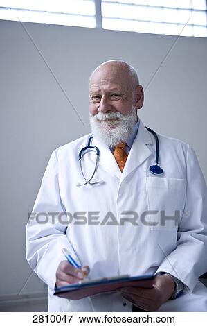 Stock Photo - Male doctor holding clipboard . Fotosearch