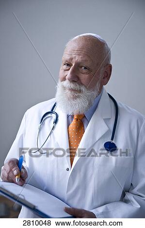 Stock Photo - Male doctor holding clipboard . Fotosearch