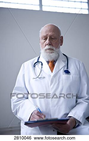 Male doctor holding clipboard View Large Photo Image Stock Photograph - Male doctor holding clipboard . Fotosearch