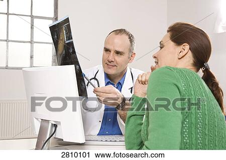 Male doctor showing x-ray report to patient View Large Photo Image Stock Image - Male doctor showing x-ray report to patient . Fotosearch