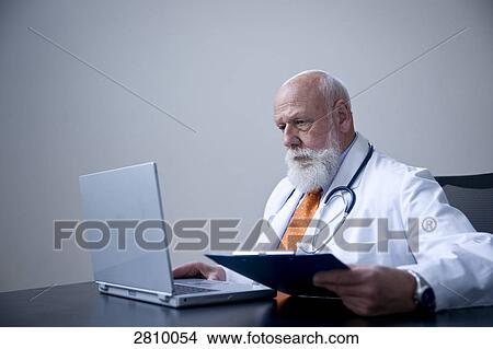 Male doctor using laptop View Large Photo Image Picture - Male doctor using laptop . Fotosearch