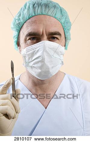 Male surgeon holding scalpel View Large Photo Image Stock Photo - Male surgeon holding scalpel . Fotosearch
