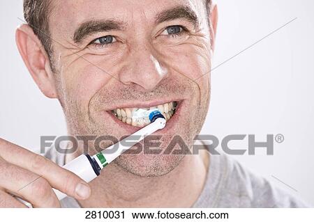 Stock Image - Man brushing his teeth . Fotosearch