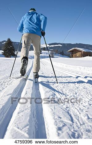 Stock Photograph - Man cross-country skiing, Tannheimer Tal, Tyrol, Austria . Fotosearch